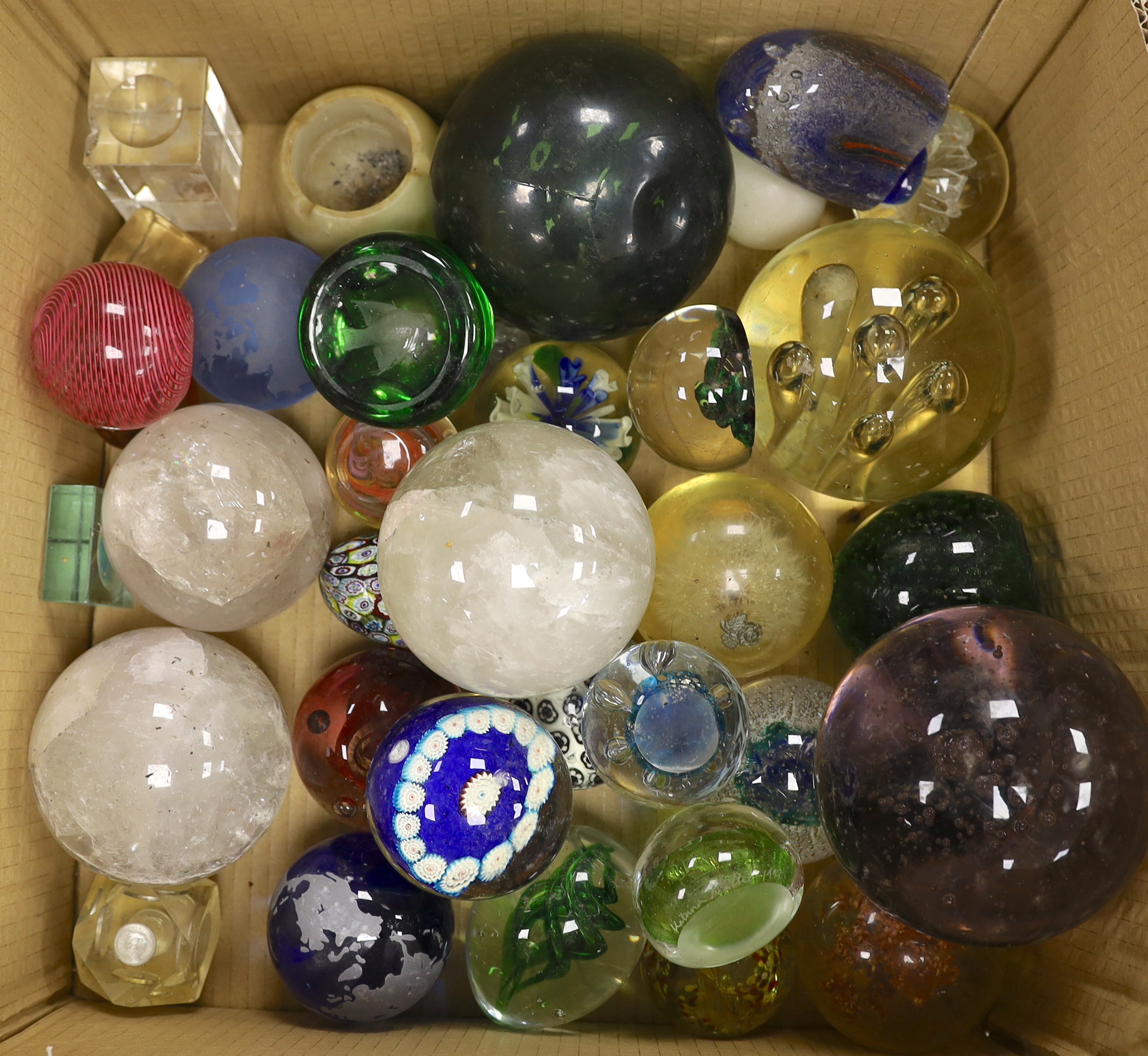 A collection of thirty three mixed glass and stone paperweights and three quartz balls